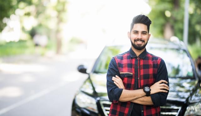 Young man by car