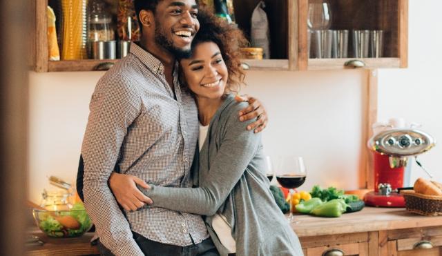 Couple hugging in kitchen