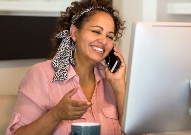 woman smiling at computer